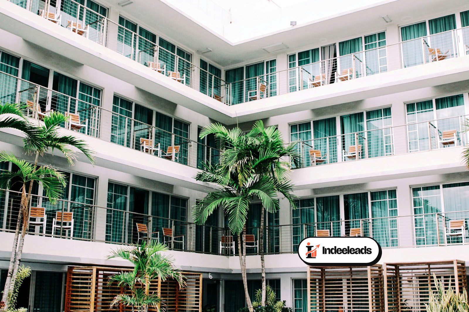 Hotel facade with balconies and palm trees