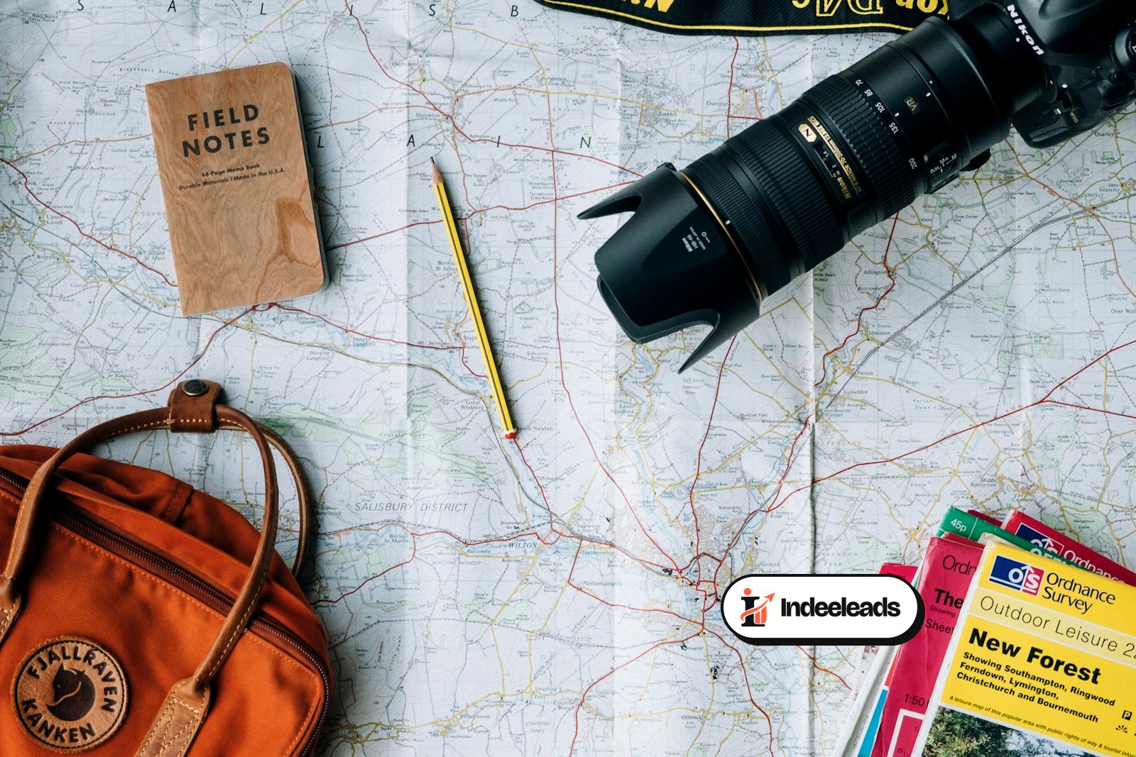 Traveller planning a trip with a map, camera and travel essentials